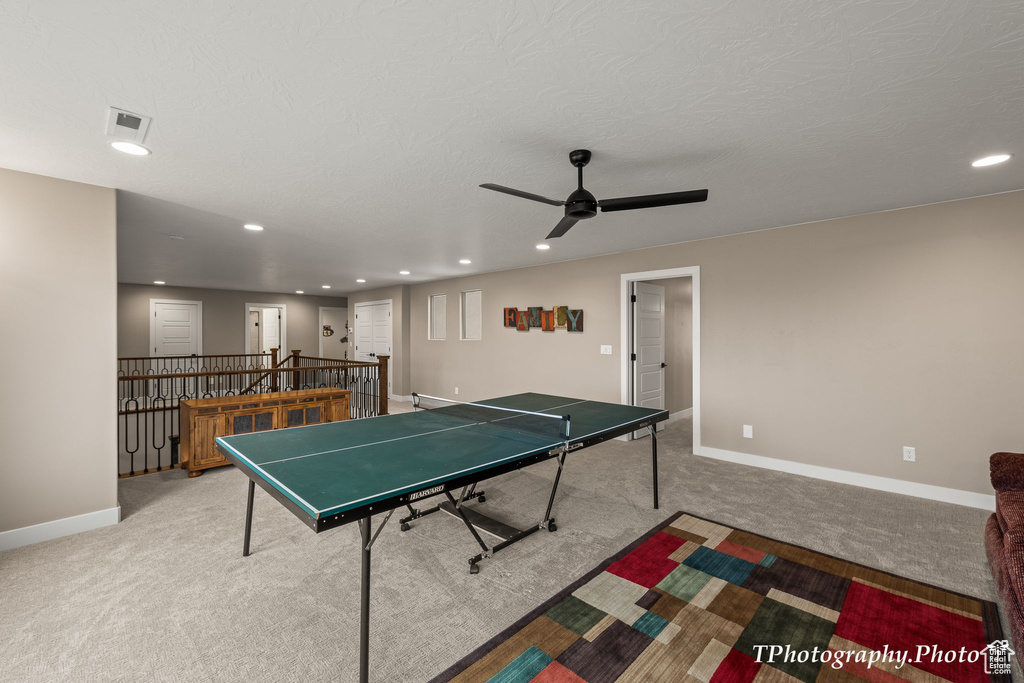 Playroom featuring ceiling fan and light carpet