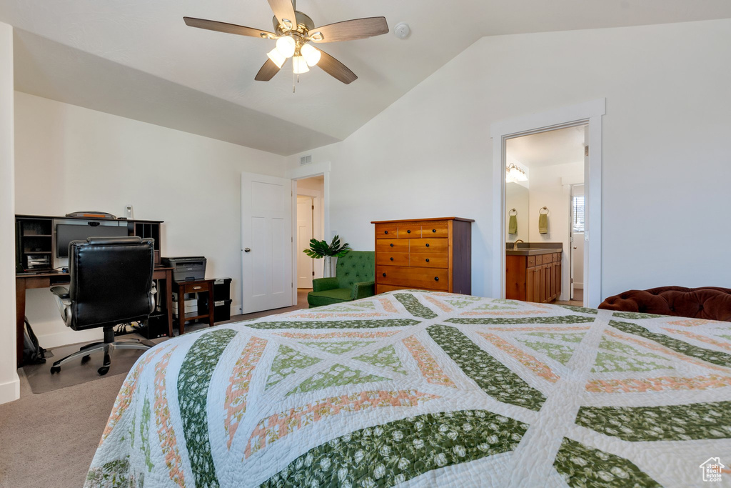 Carpeted bedroom with lofted ceiling, ceiling fan, and connected bathroom
