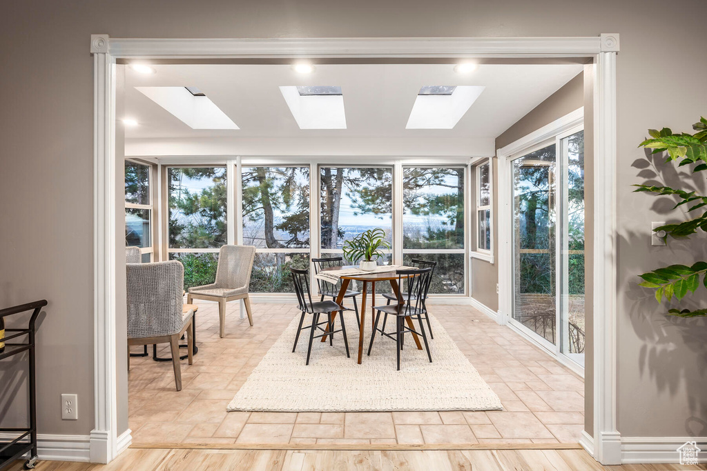 Sunroom featuring plenty of natural light and a skylight