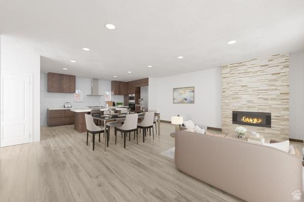 Dining space featuring light hardwood / wood-style flooring and a tile fireplace