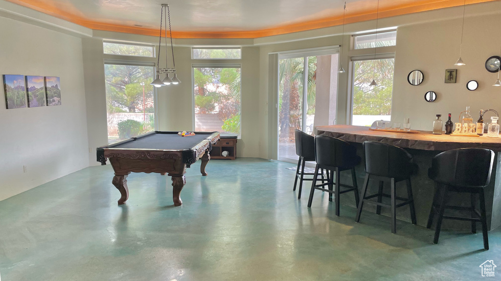 Game room with indoor bar, pool table, and concrete floors