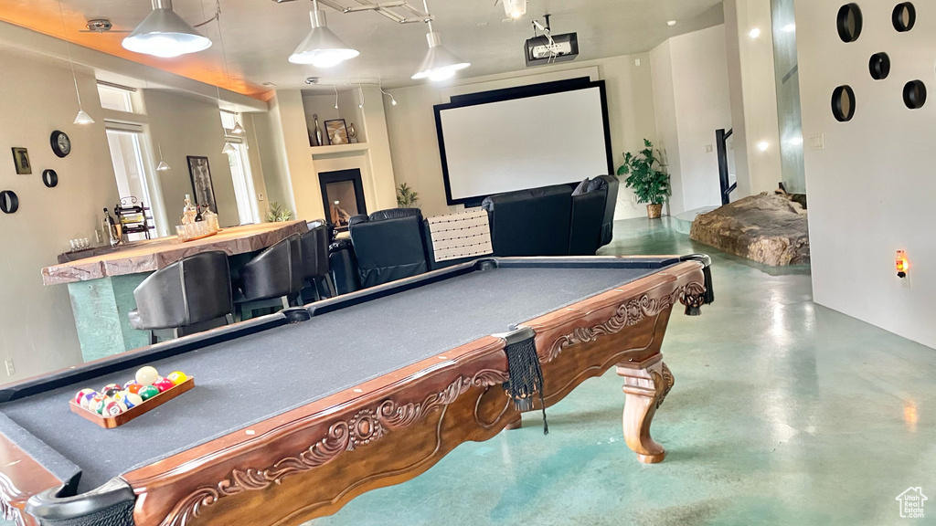 Game room featuring bar, billiards, and concrete floors