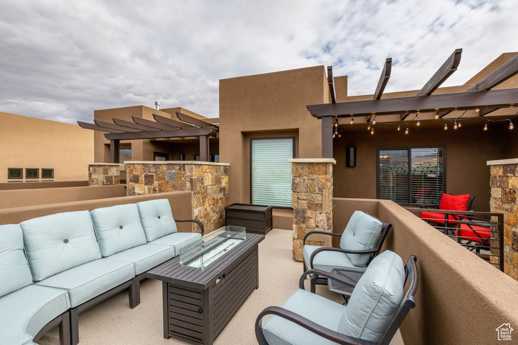 View of terrace featuring an outdoor living space with a fireplace