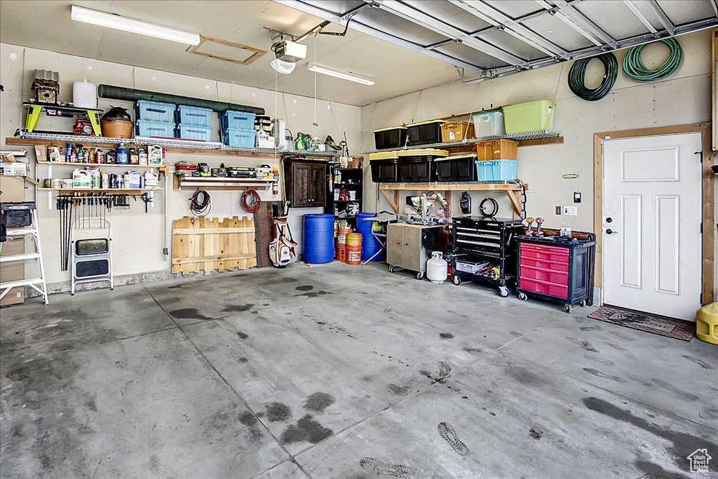 Garage with a garage door opener and a workshop area