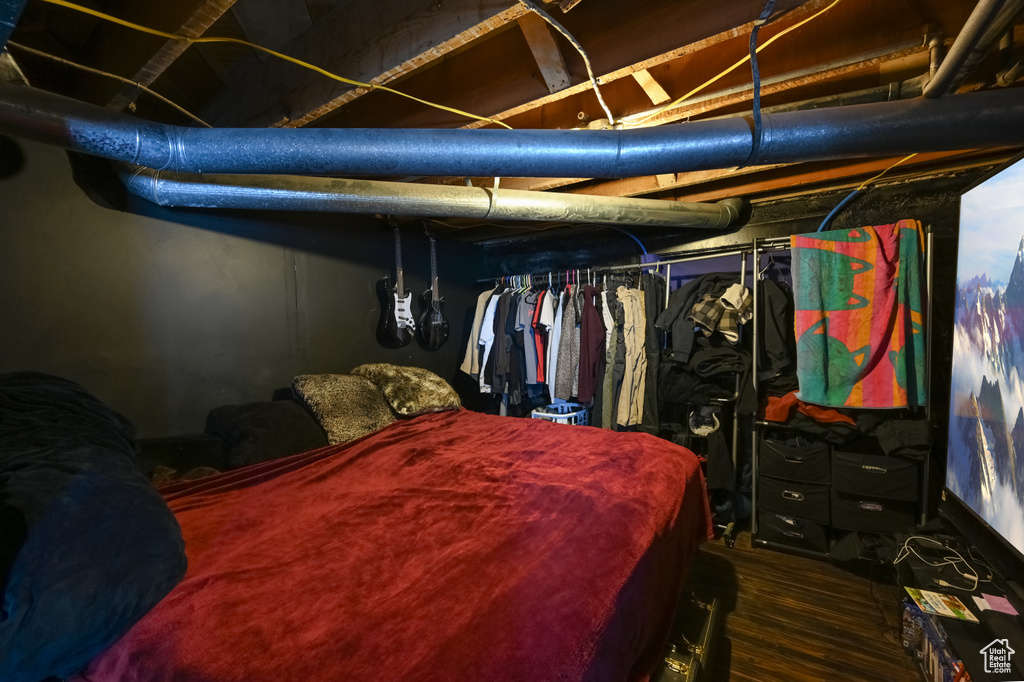 Bedroom featuring a closet and dark hardwood / wood-style flooring