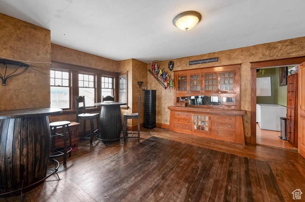 Office featuring dark hardwood / wood-style flooring and bar area