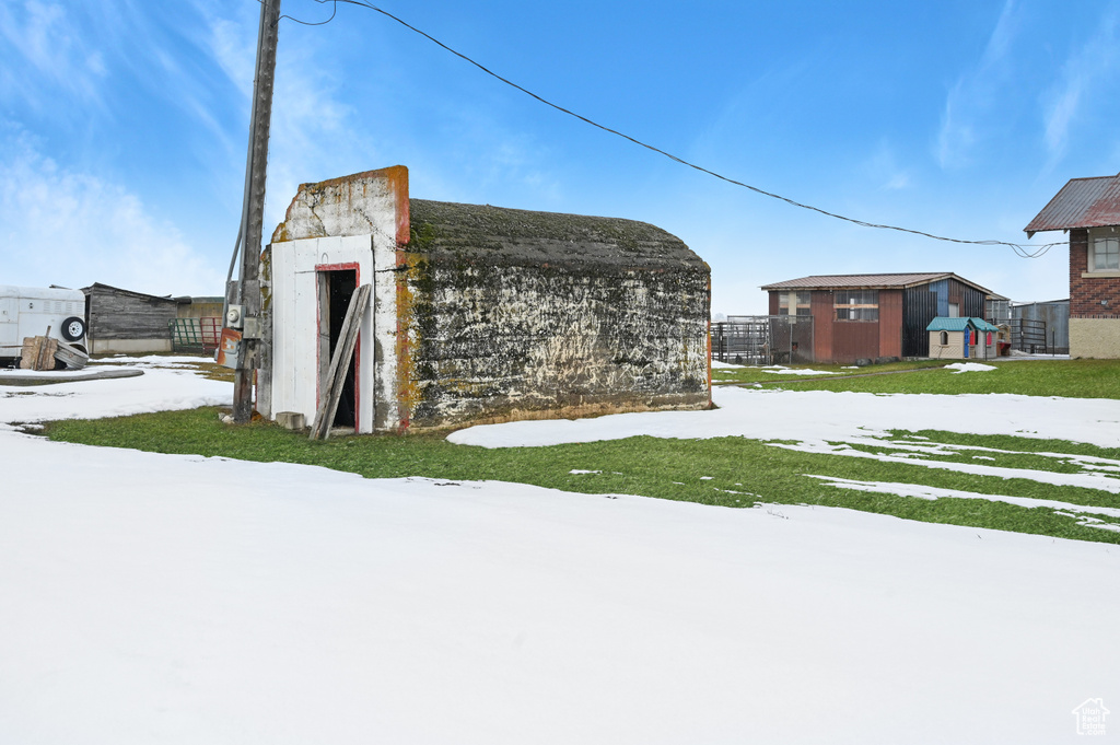 Yard covered in snow with an outdoor structure