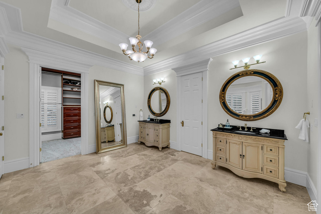 Bathroom featuring a chandelier, a tray ceiling, and tile flooring