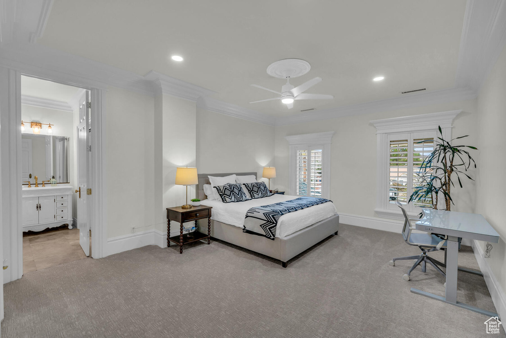 Bedroom with light carpet, ceiling fan, ensuite bathroom, and ornamental molding