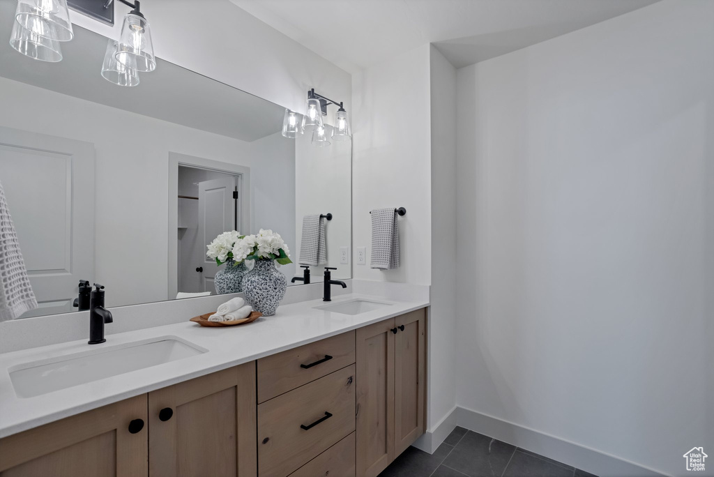Bathroom featuring dual vanity and tile floors