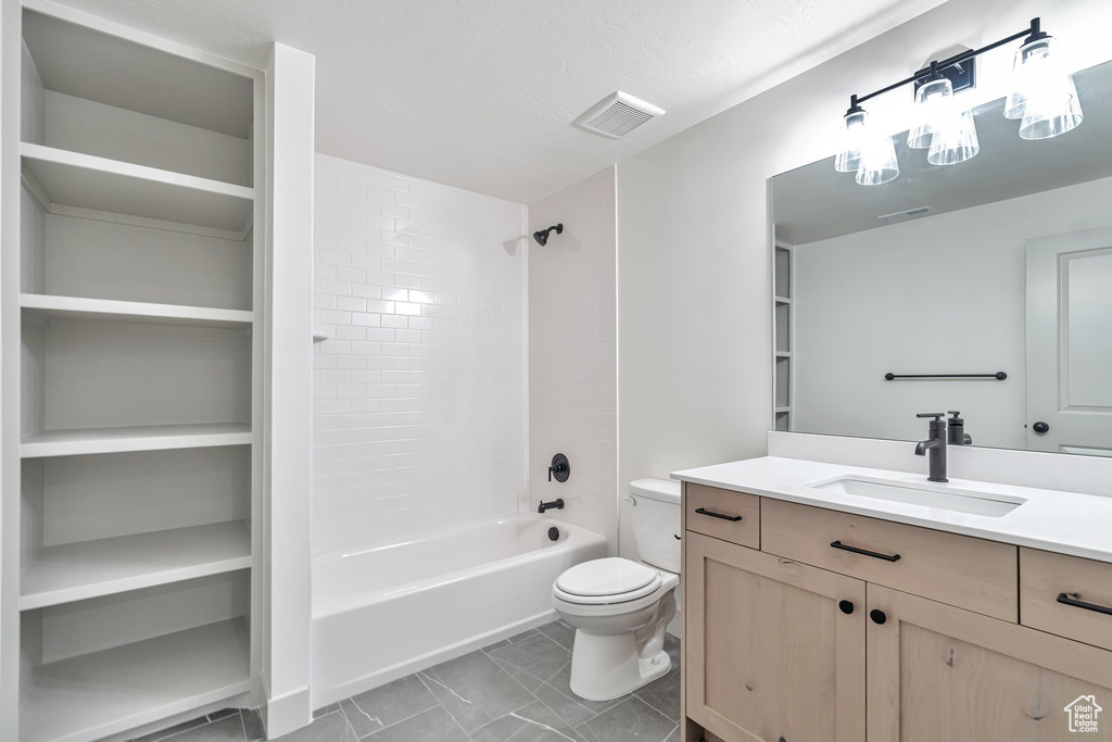 Full bathroom featuring shower / bath combination, vanity, tile flooring, and toilet