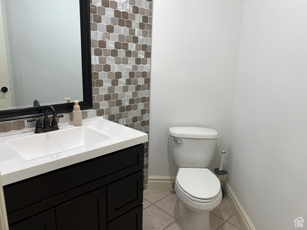 Bathroom with vanity, toilet, and tile floors