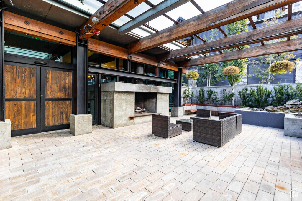 View of patio / terrace featuring a pergola and an outdoor living space with a fireplace