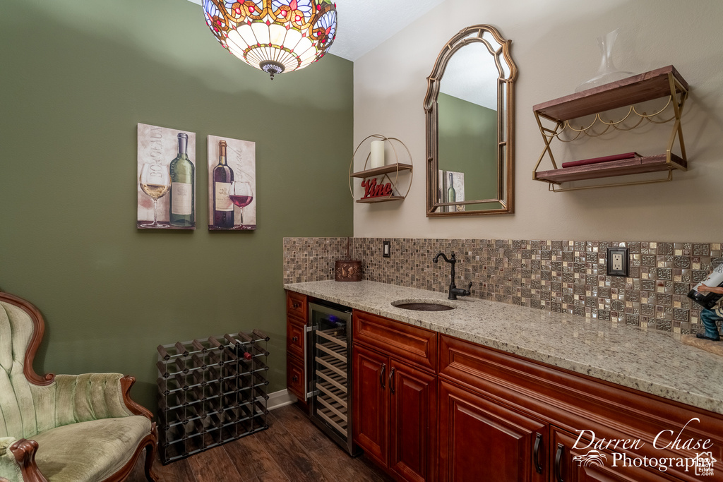 Bathroom featuring vanity, hardwood / wood-style flooring, backsplash, and beverage cooler