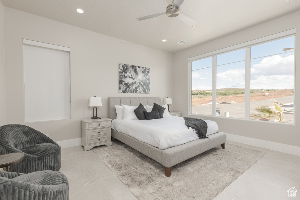 Bedroom featuring ceiling fan and light tile floors