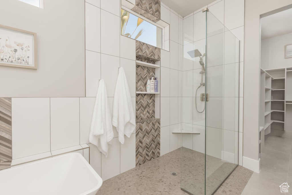 Bathroom featuring an enclosed shower and a healthy amount of sunlight
