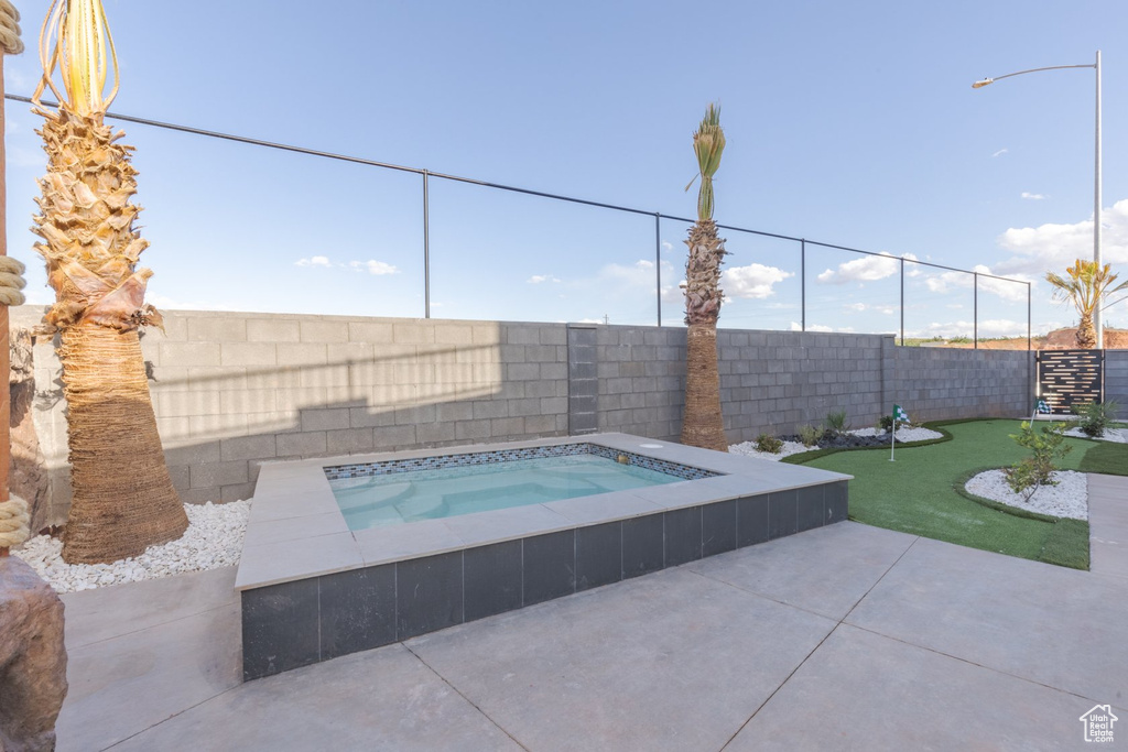 View of swimming pool featuring an in ground hot tub and a patio area