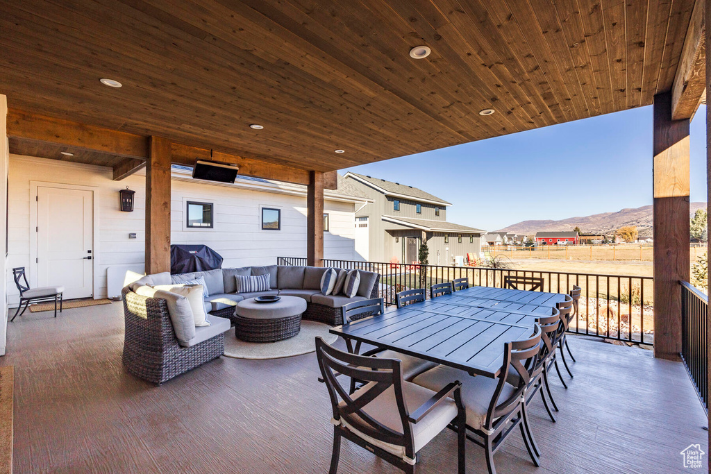 View of patio featuring a mountain view and an outdoor living space