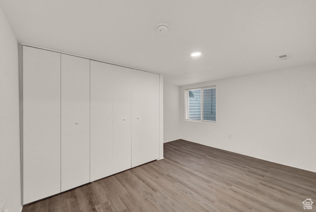 Unfurnished bedroom with a closet and light wood-type flooring