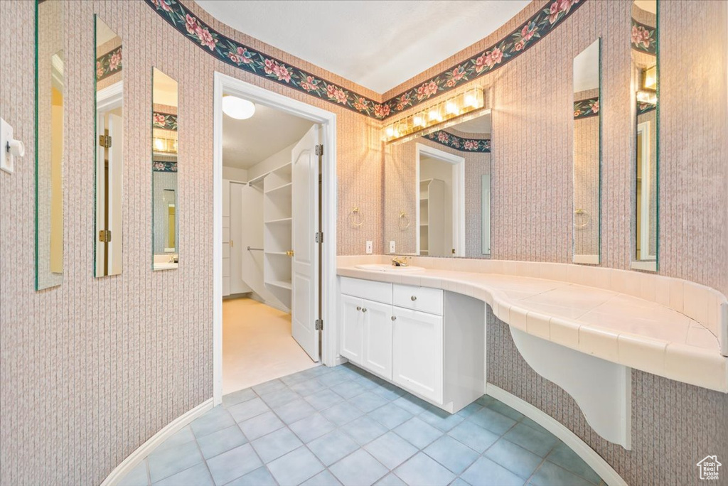 Bathroom featuring large vanity and tile floors