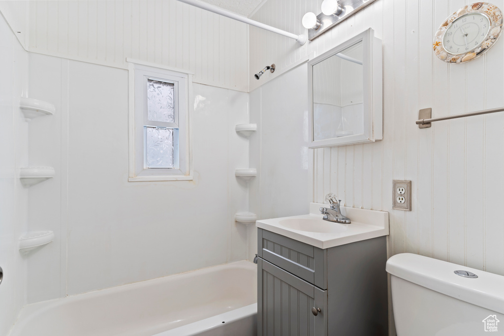 Full bathroom with vanity with extensive cabinet space, shower / bath combination, and toilet
