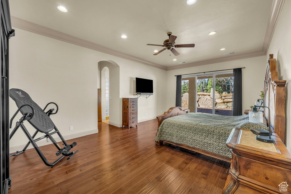 Bedroom featuring access to outside, dark hardwood / wood-style floors, ceiling fan, and crown molding
