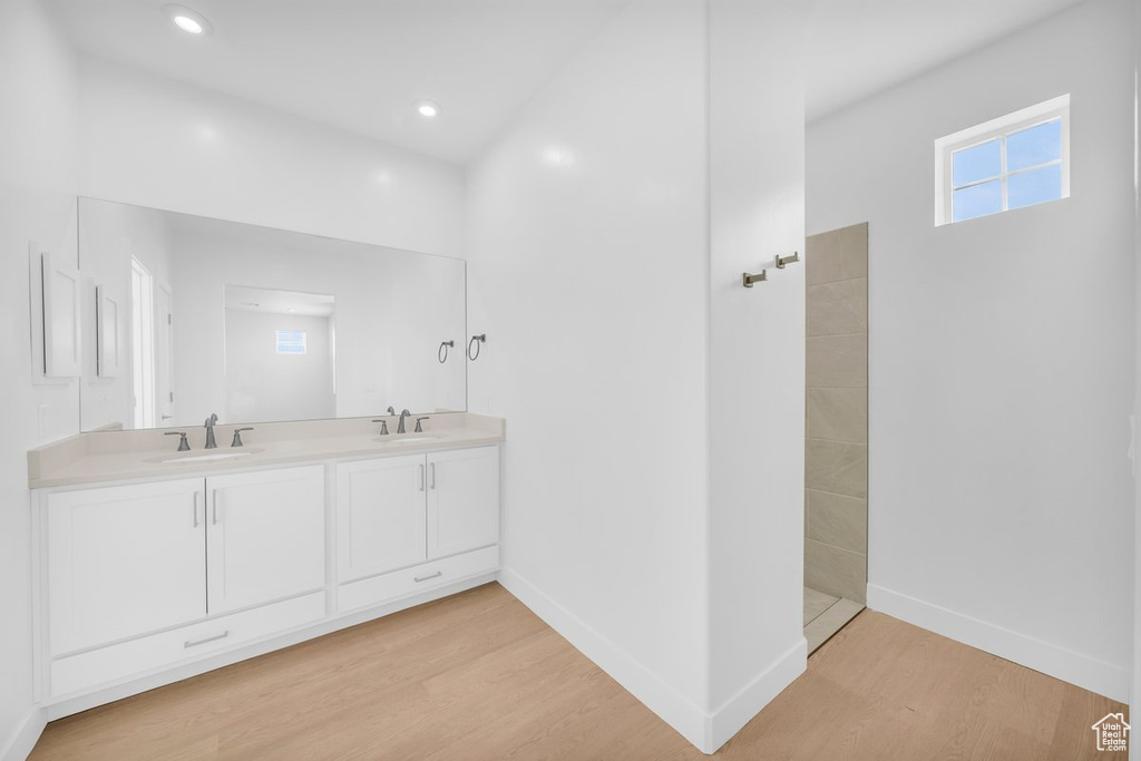 Bathroom featuring double sink vanity and hardwood / wood-style flooring
