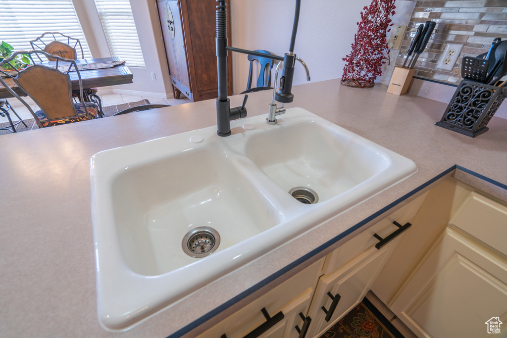 Room details featuring sink and backsplash