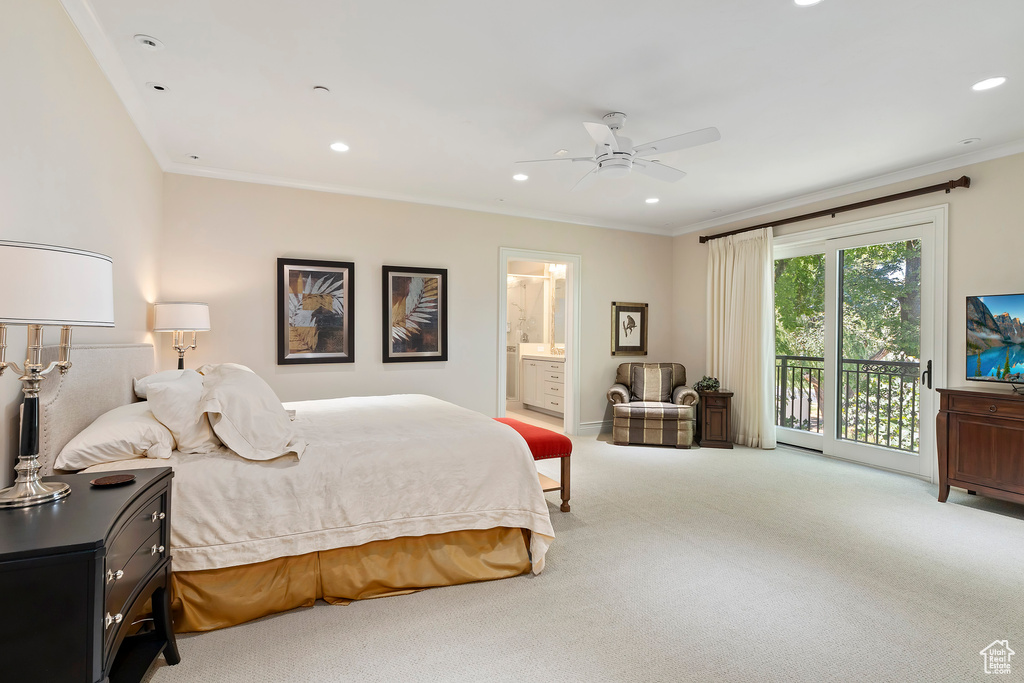 Bedroom featuring access to exterior, ensuite bath, light colored carpet, and ceiling fan