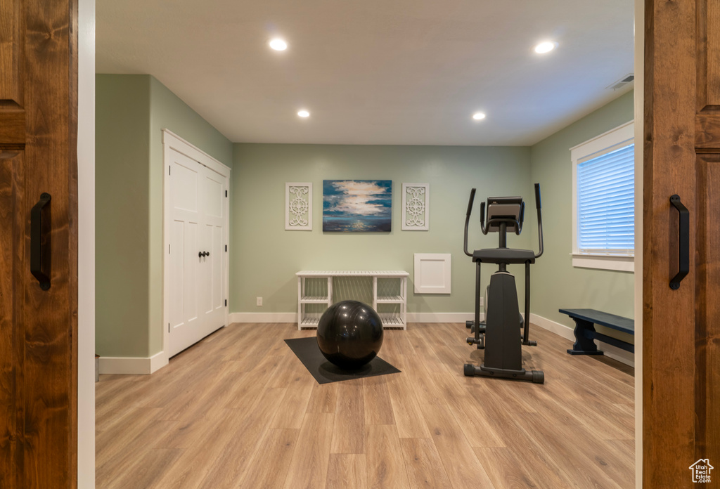 Exercise area featuring light hardwood / wood-style floors