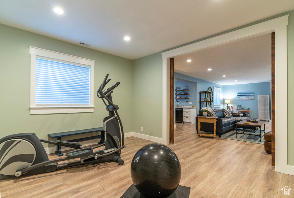 Workout room featuring light hardwood / wood-style floors