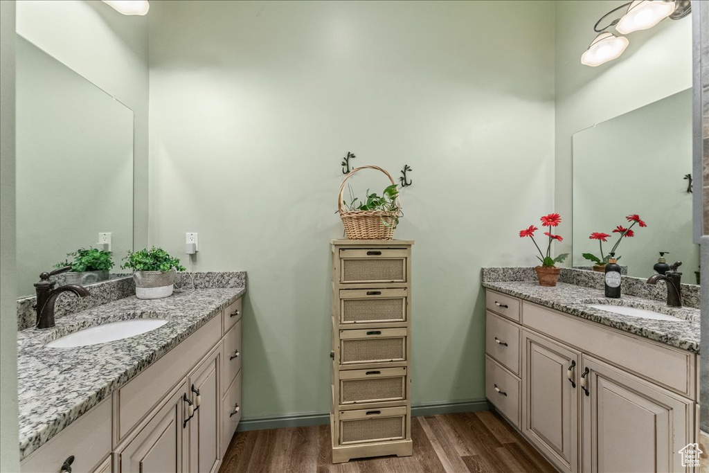 Bathroom with double sink vanity and hardwood / wood-style flooring