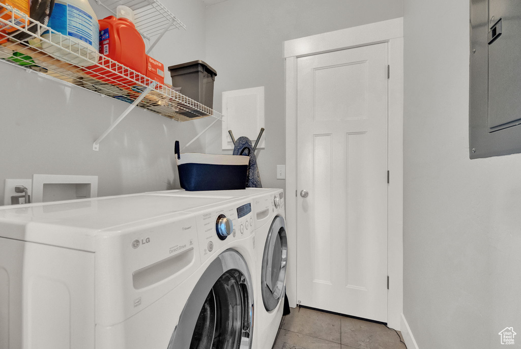 Laundry area featuring hookup for a washing machine, light tile floors, and washer and dryer