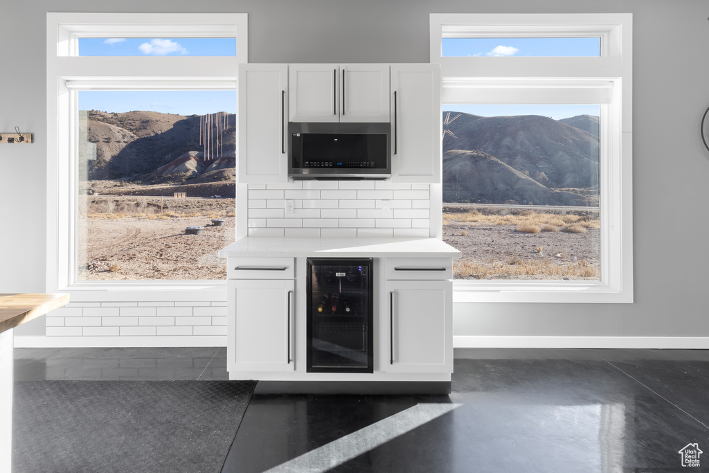 Interior details with tasteful backsplash, wine cooler, and a mountain view