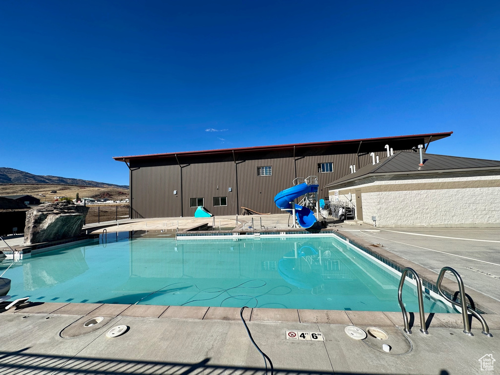 View of pool featuring a patio area and a mountain view