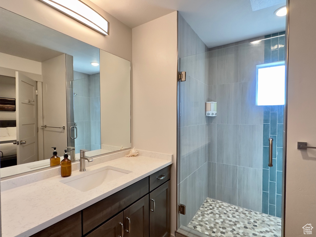 Bathroom with vanity and a shower with shower door