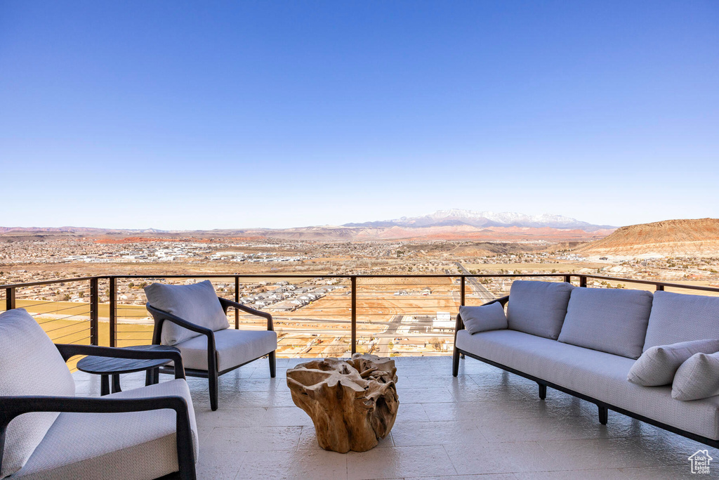 View of patio with an outdoor living space and a mountain view