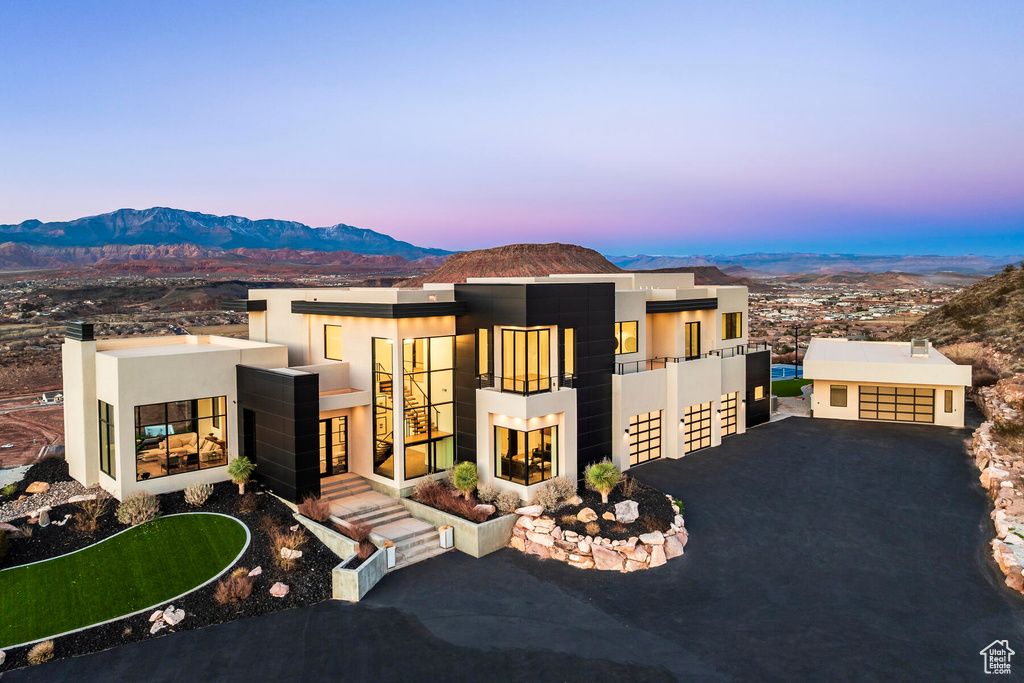 View of front of house featuring a mountain view and a garage