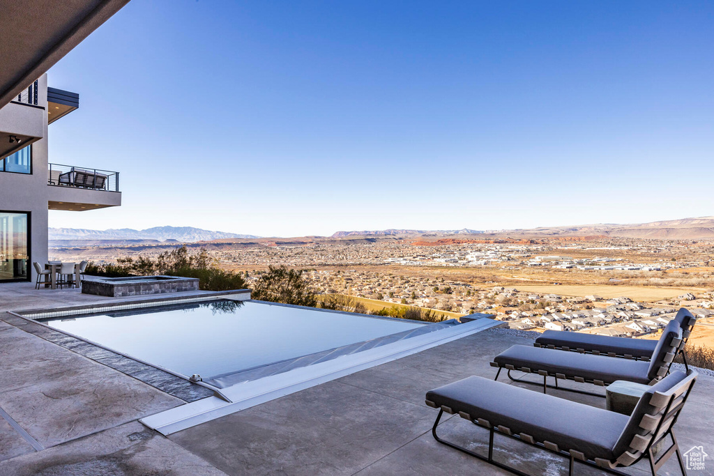 View of swimming pool featuring a mountain view and a patio