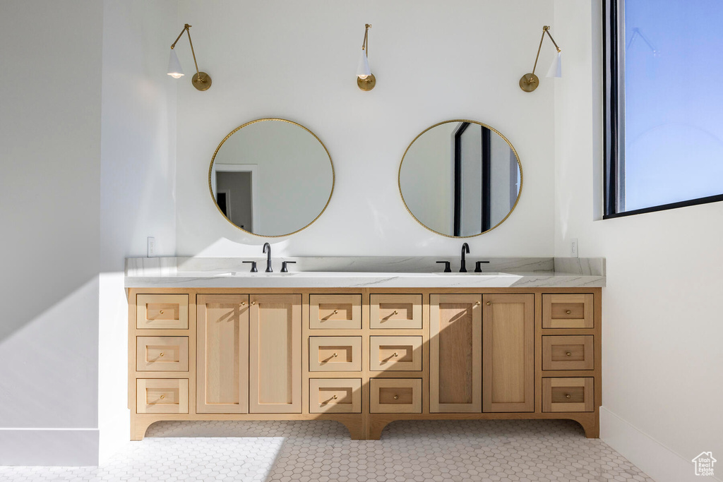 Bathroom with double vanity and tile patterned floors