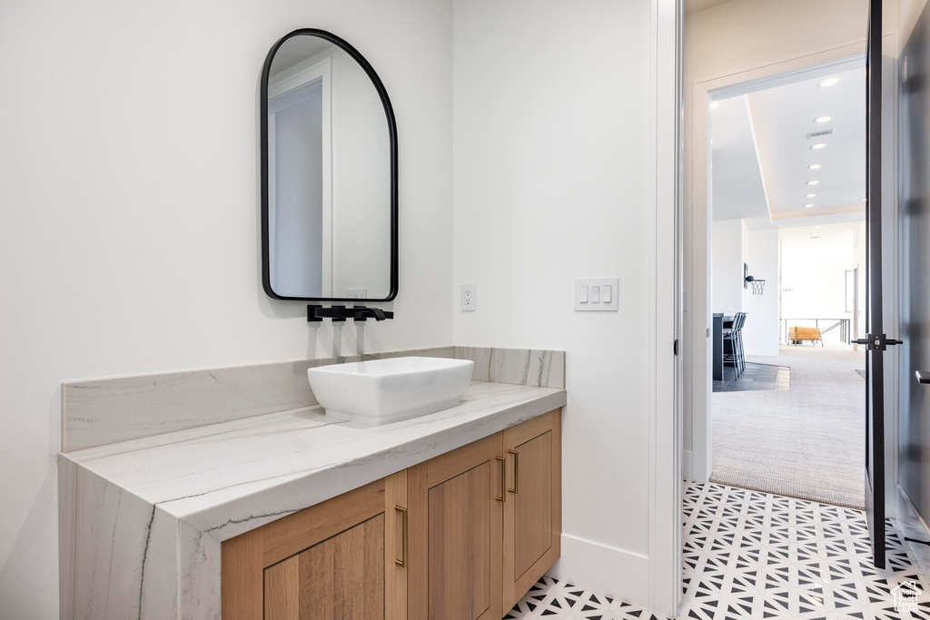 Bathroom featuring tile patterned flooring and vanity