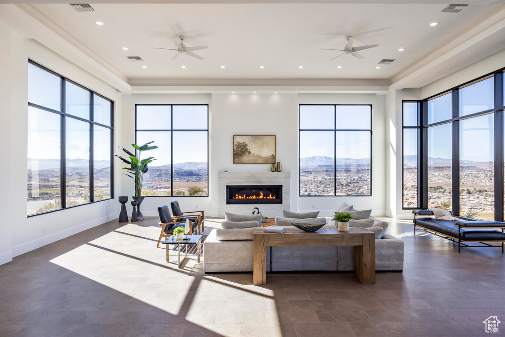 Living room featuring a fireplace, a mountain view, and ceiling fan