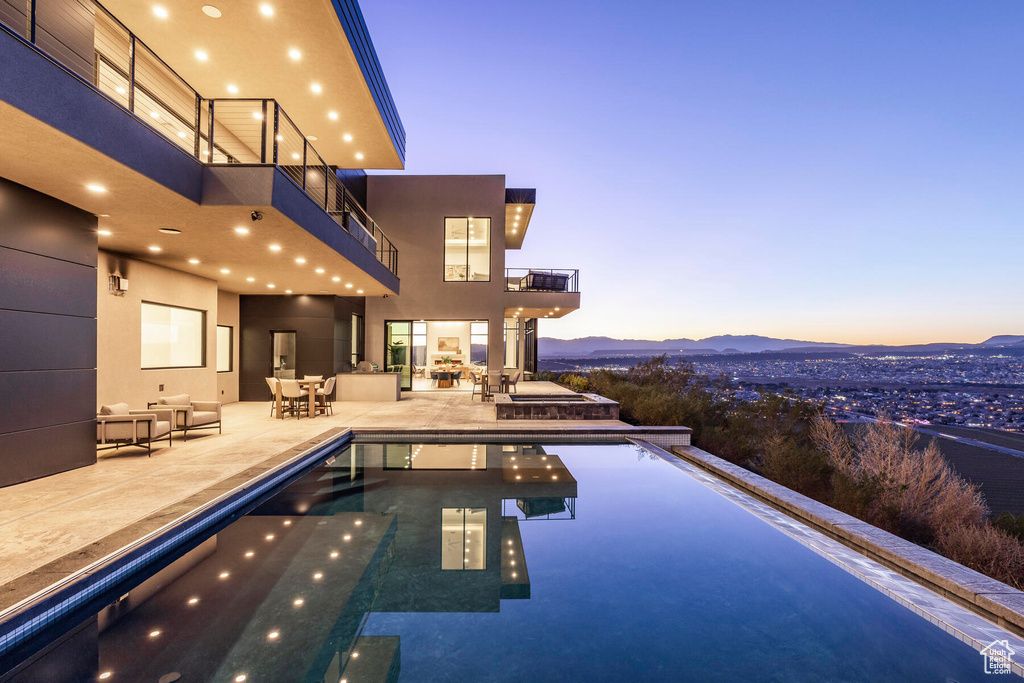 Pool at dusk with a patio