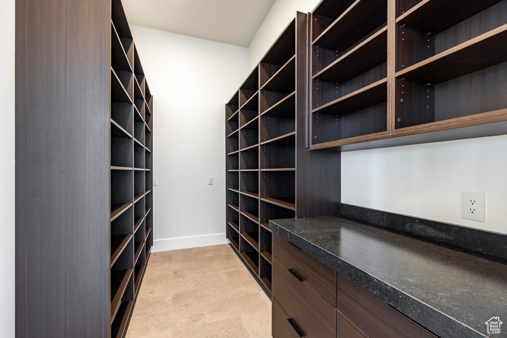 Walk in closet featuring light tile patterned flooring