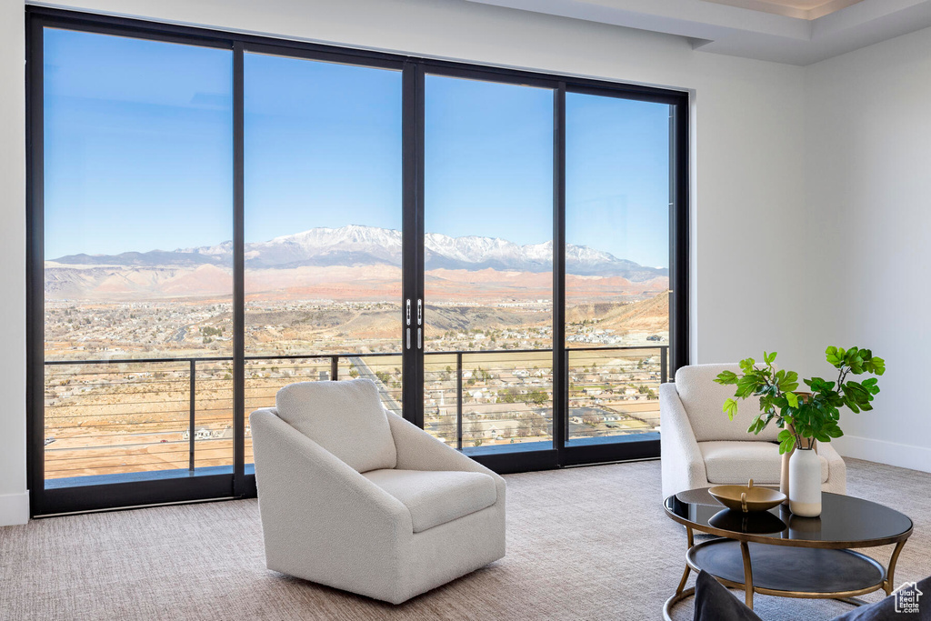 Living area featuring a mountain view and carpet flooring