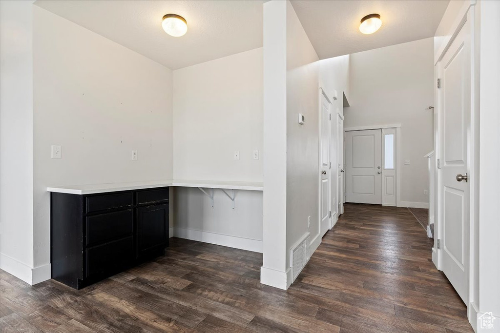 Hallway with dark hardwood / wood-style floors