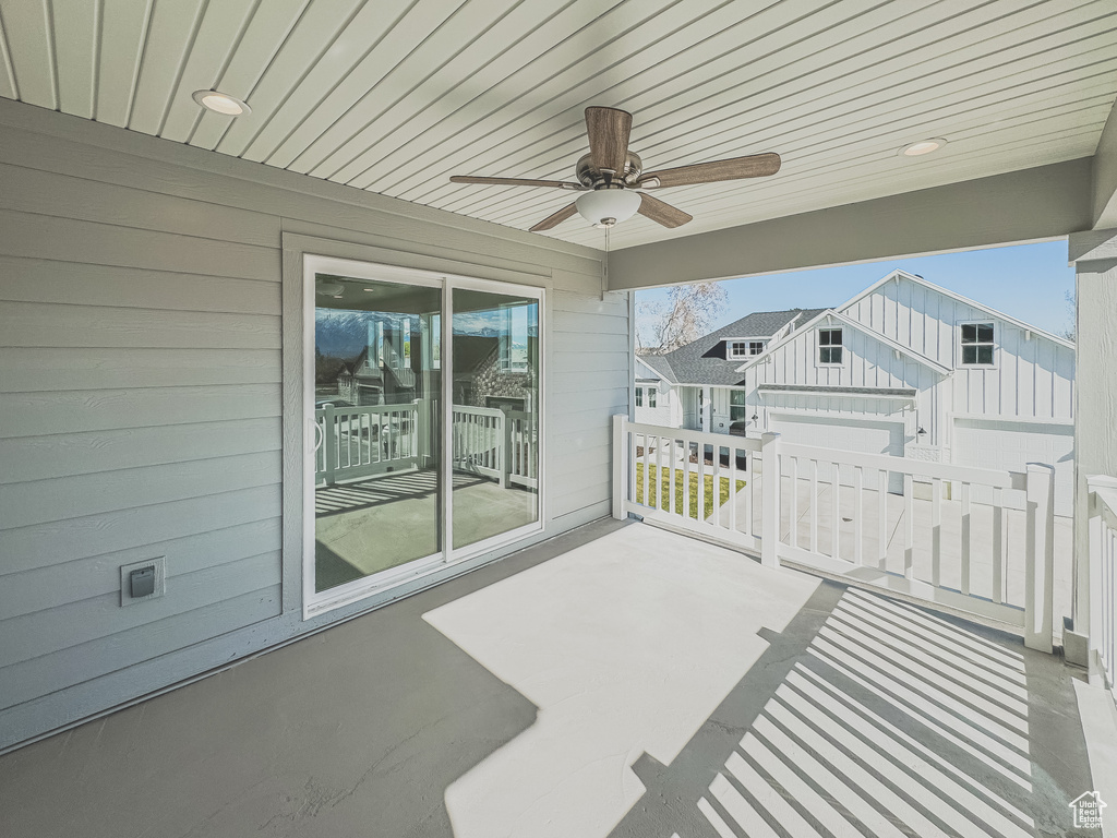 View of patio featuring ceiling fan and a garage