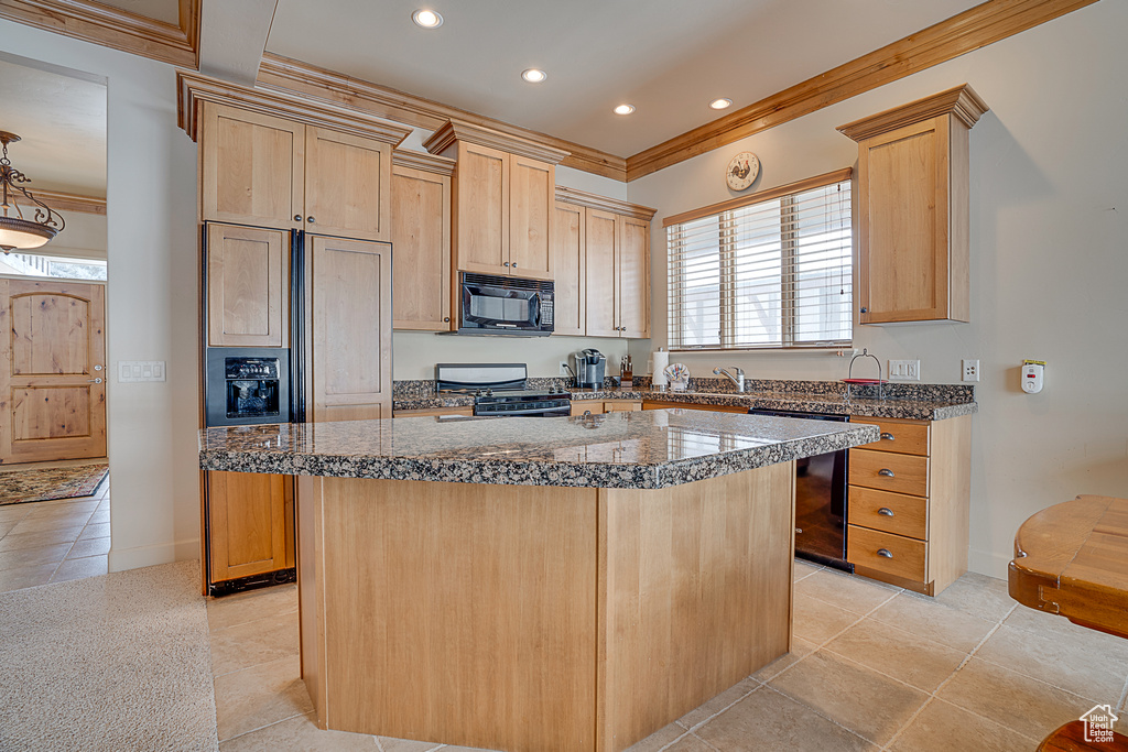 Kitchen featuring dishwasher, light brown cabinetry, a center island, stove, and light tile flooring