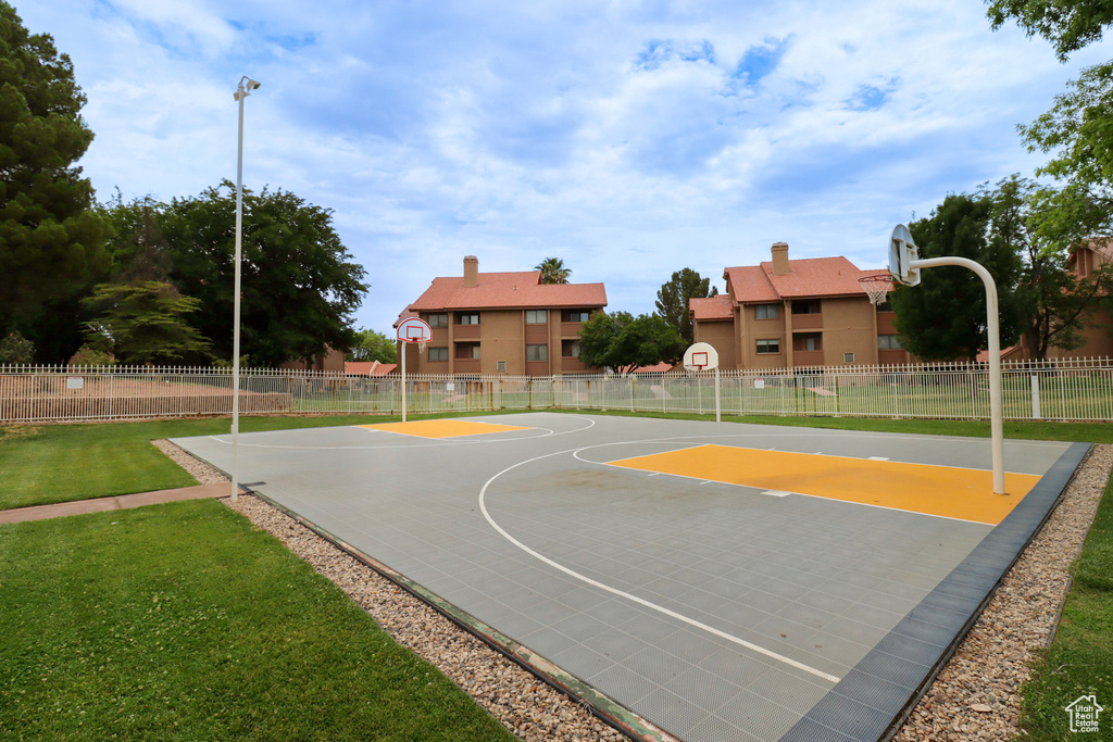 View of basketball court with a lawn