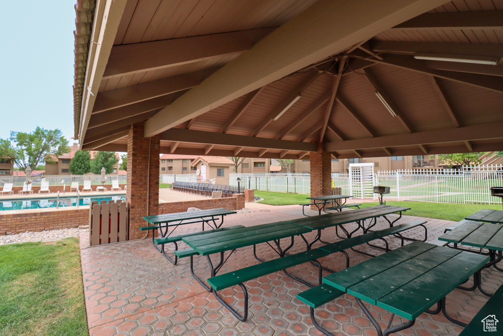 View of patio with a gazebo and a community pool